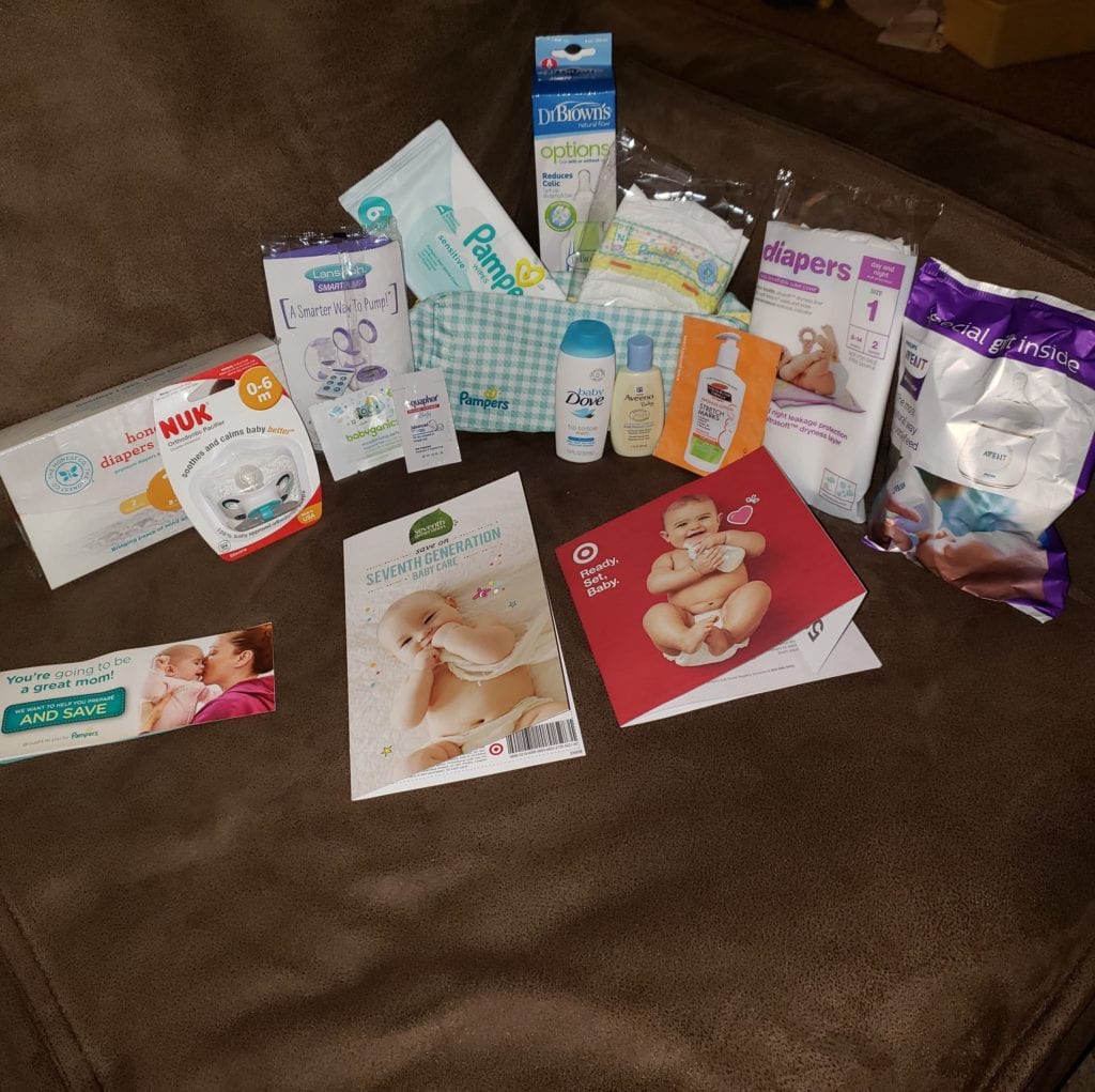 picture of target baby registry free gift inserts, coupons, and baby items laid out on a couch