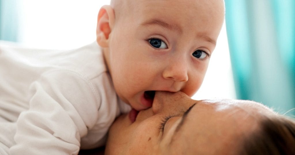 baby biting mom's nose - it's better than biting while breastfeeding!