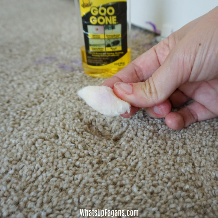 purple acryclic paint residue on a cotton ball soaked in Goo Gone - one method for how to remove acrylic paint from carpet