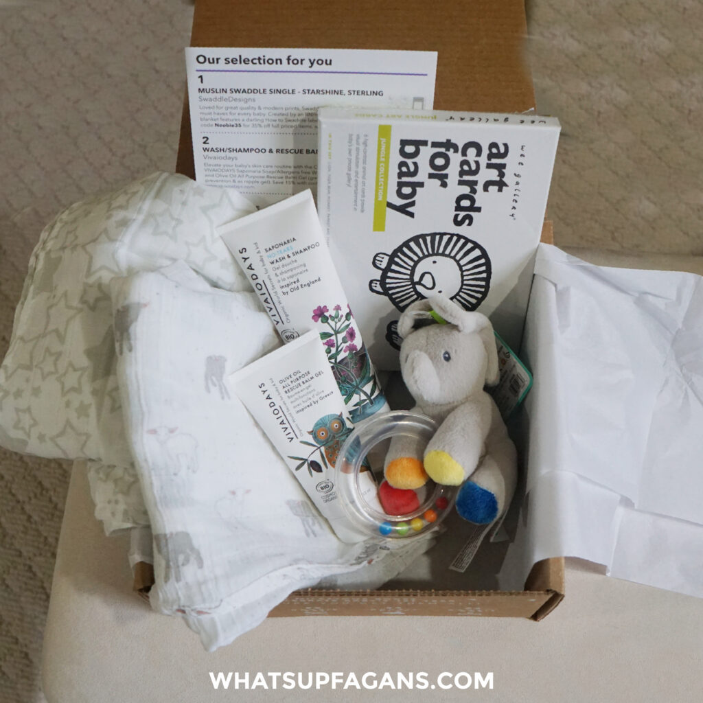 Noobie Nest review 2021 - the contents of the January 2021 Noobie Nest box with swaddles, baby wash and healing balm, art cards for babies, and a rattle